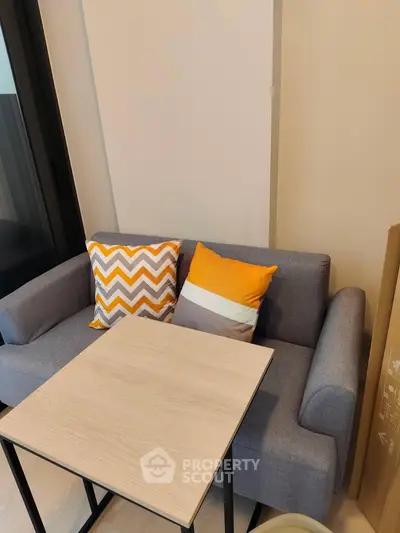 Cozy living room with modern sofa and stylish cushions, perfect for relaxation and comfort.