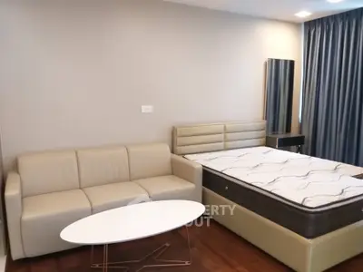 Modern bedroom with stylish sofa and bed, perfect for cozy living.