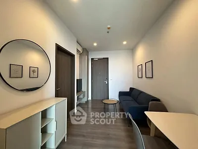 Modern living room with stylish decor and cozy seating in a contemporary apartment.