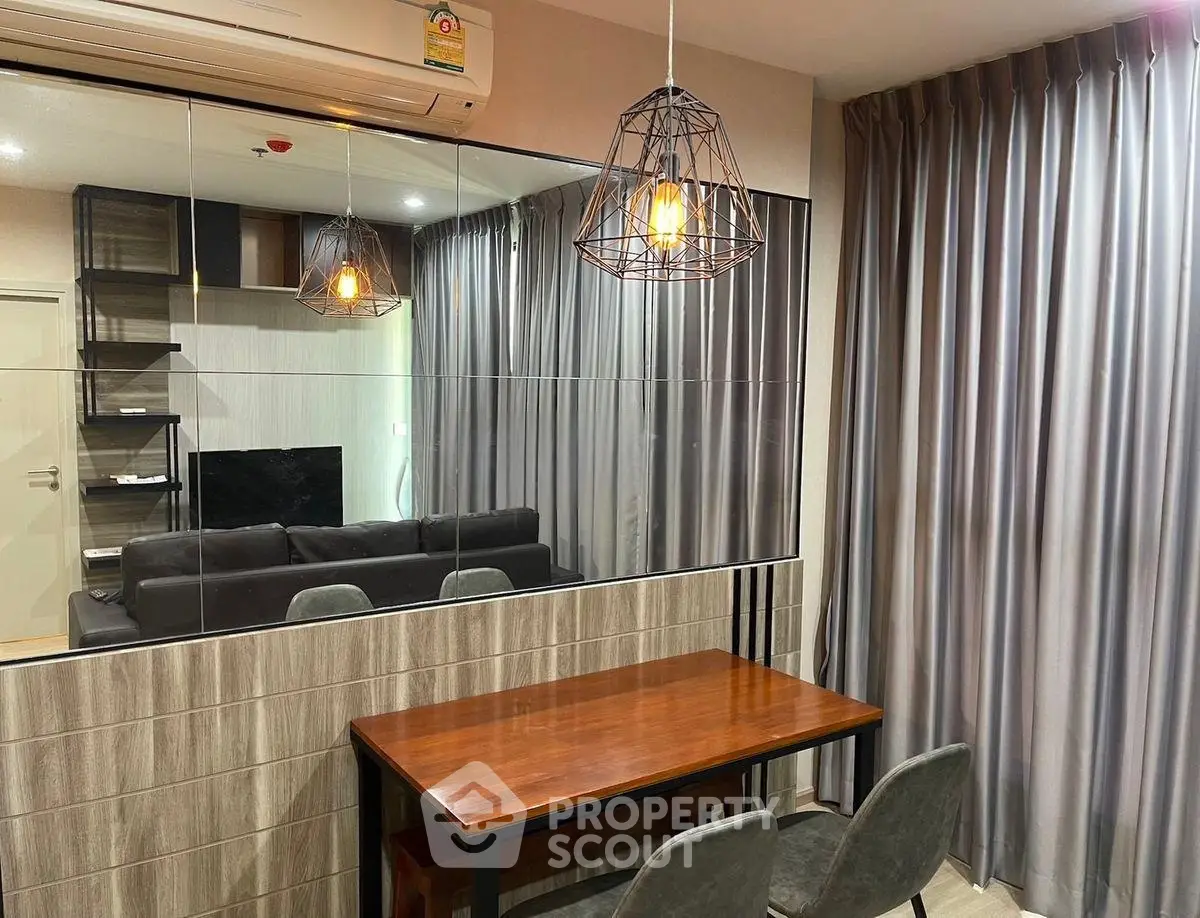 Modern living room with stylish lighting and mirrored wall accent