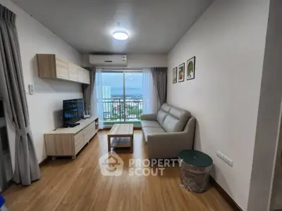 Modern living room with city view, stylish furniture, and wooden flooring.