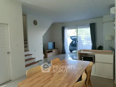 Spacious open-plan living area with modern kitchen and dining set