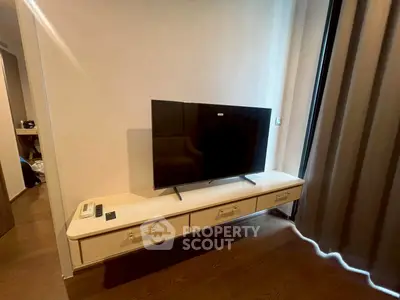 Modern living room with sleek TV setup and elegant curtains