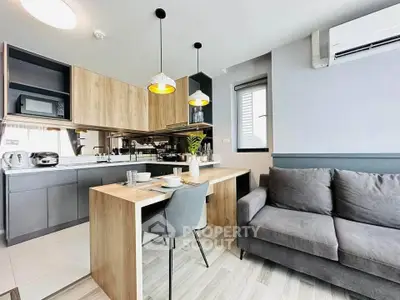 Modern open-layout kitchen and living room with stylish decor and natural light