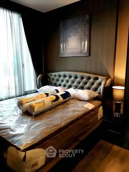 Luxurious bedroom with elegant decor and plush bedding in modern apartment.