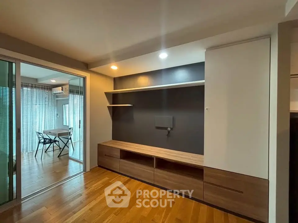Modern living room with wooden flooring and sleek built-in storage unit