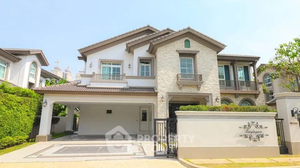 Luxurious two-story house with elegant stone facade and spacious driveway in upscale neighborhood.