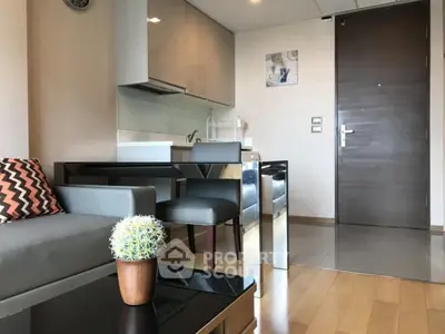 Modern apartment interior with sleek kitchen and cozy living area, featuring stylish furniture and decor.