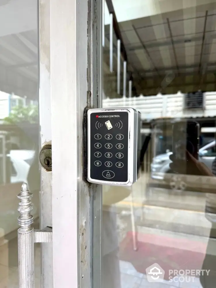 Secure building entrance with modern access control keypad