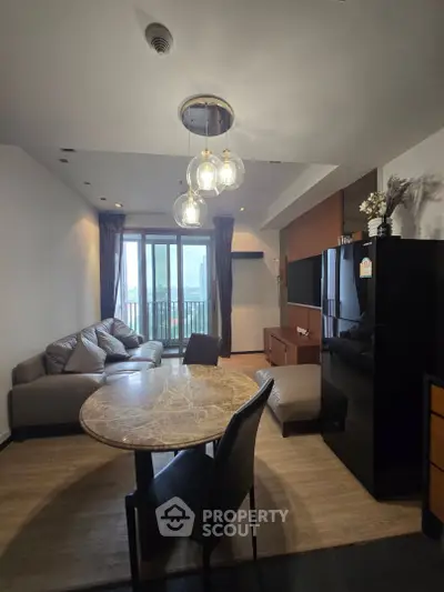 Modern living room with stylish furniture and balcony view