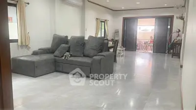 Spacious living room with modern gray sofa and elegant decor