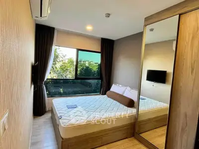 Modern bedroom with large window and mirrored wardrobe
