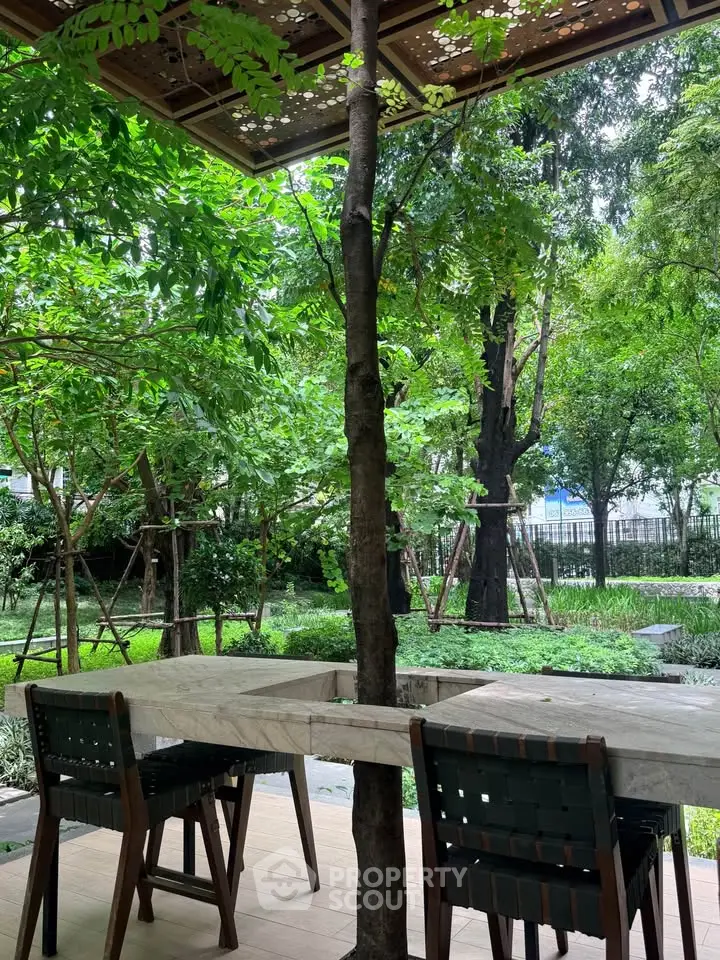 Charming garden view with outdoor seating in lush green surroundings, perfect for relaxation and leisure.