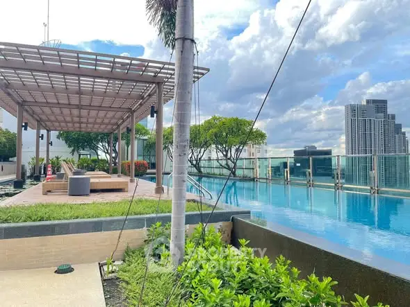 Luxurious rooftop pool with stunning city views and modern lounging area.
