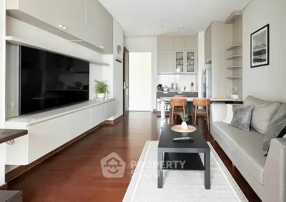 Modern living room with sleek furniture and open kitchen layout, perfect for contemporary urban living.