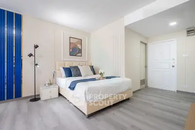 Modern bedroom with stylish decor and cozy ambiance, featuring a comfortable bed and elegant furnishings.