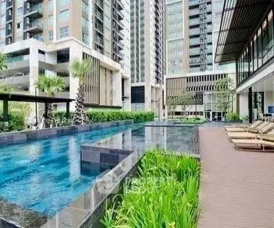 Luxurious modern apartment complex with stunning pool and lush greenery
