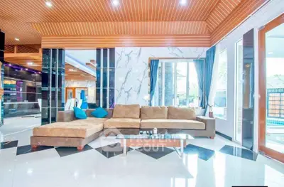 Luxurious modern living room with elegant decor and spacious seating area.