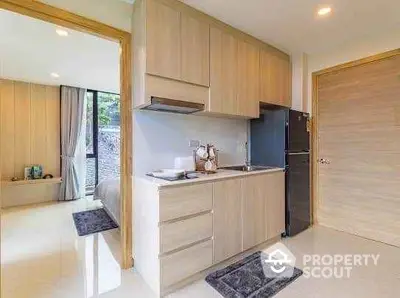 Modern kitchen with sleek cabinetry and open layout in a stylish apartment