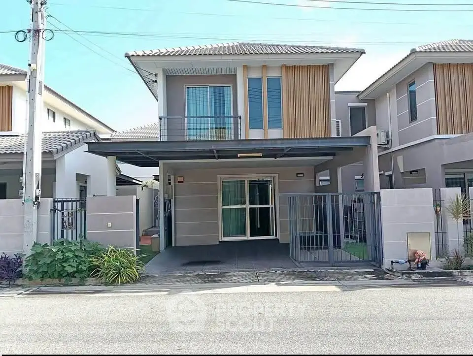 Modern two-story house with spacious driveway and contemporary design.