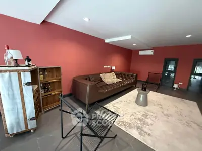 Stylish living room with modern furniture and red accent wall