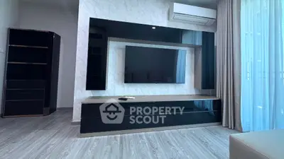 Modern living room with sleek black entertainment unit and wall-mounted TV
