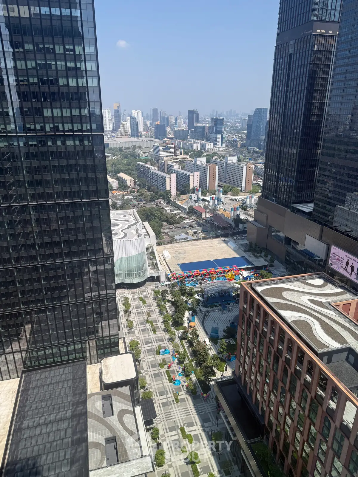 Stunning cityscape view from a high-rise building showcasing urban architecture and vibrant city life.