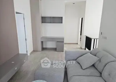 Modern living room with sleek grey furniture and minimalist design