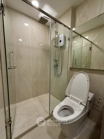 Modern bathroom with glass shower enclosure and sleek toilet design