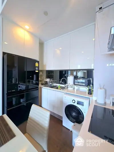 Modern kitchen with sleek appliances and ample storage space