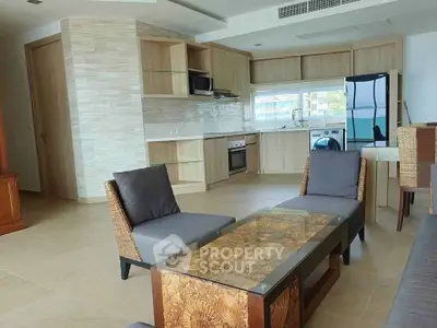 Spacious open-plan living room with modern kitchen and stylish furniture in a contemporary apartment.