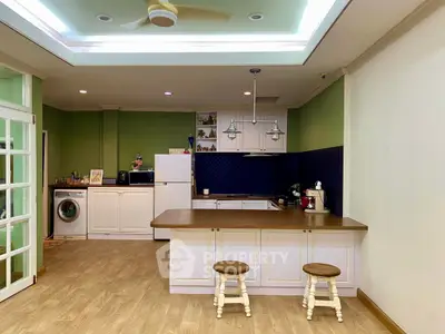 Charming open-layout kitchen with modern appliances and cozy seating area, perfect for entertaining.