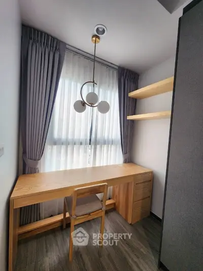 Modern study room with elegant wooden desk and shelves, featuring stylish lighting and floor-to-ceiling curtains.