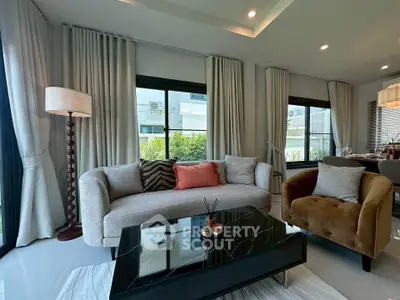 Luxurious living room with modern furniture and large windows