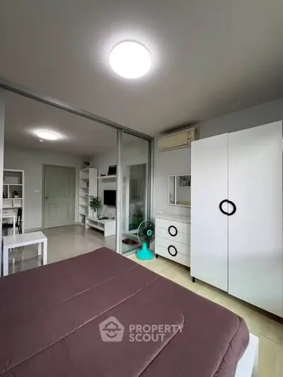 Modern bedroom with sleek furniture and sliding glass doors