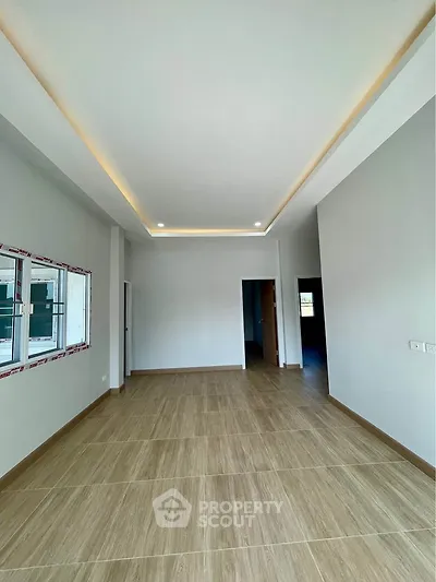 Spacious modern living room with elegant ceiling lights and large windows