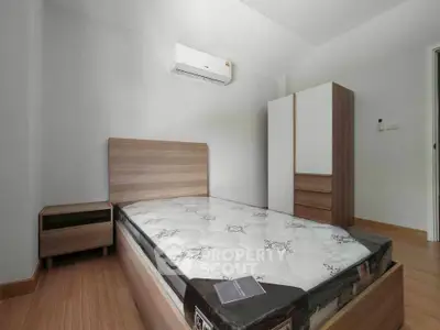 Modern bedroom with wooden flooring and minimalist furniture design