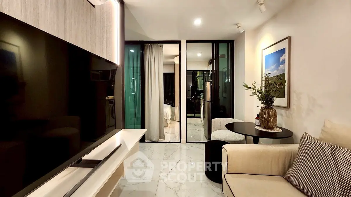 Modern living room with sleek TV and cozy seating area