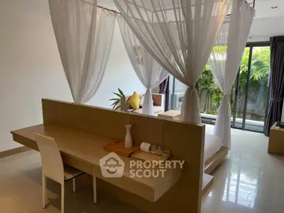 Luxurious bedroom with canopy bed and garden view, featuring elegant decor and natural light.