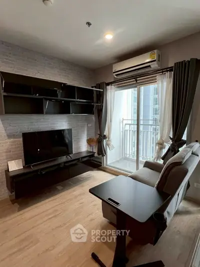 Modern living room with balcony, sleek furniture, and natural light.