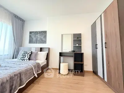 Spacious bedroom with modern decor and ample natural light