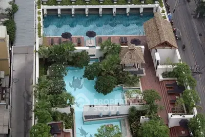 Luxurious rooftop pool with lush greenery and city views