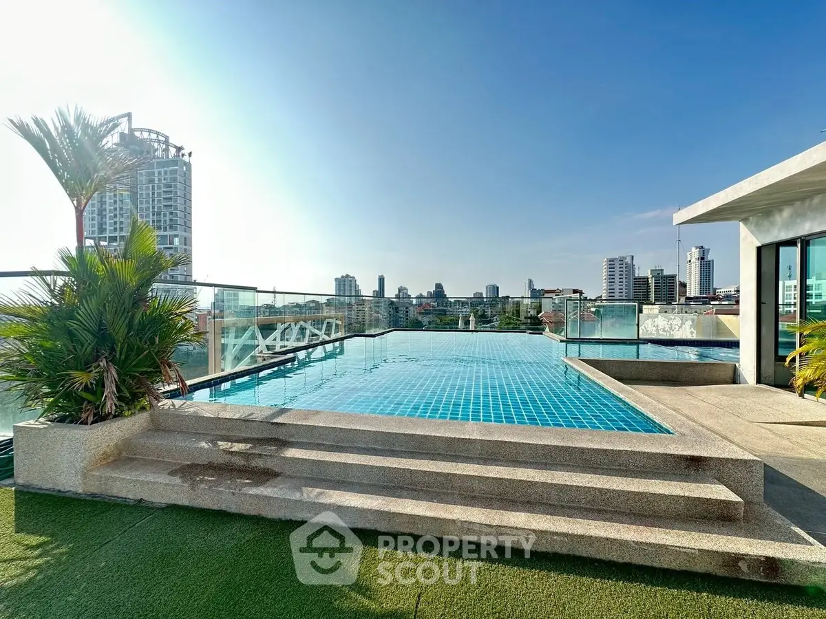 Luxurious rooftop pool with stunning city skyline views, perfect for relaxation and entertainment.