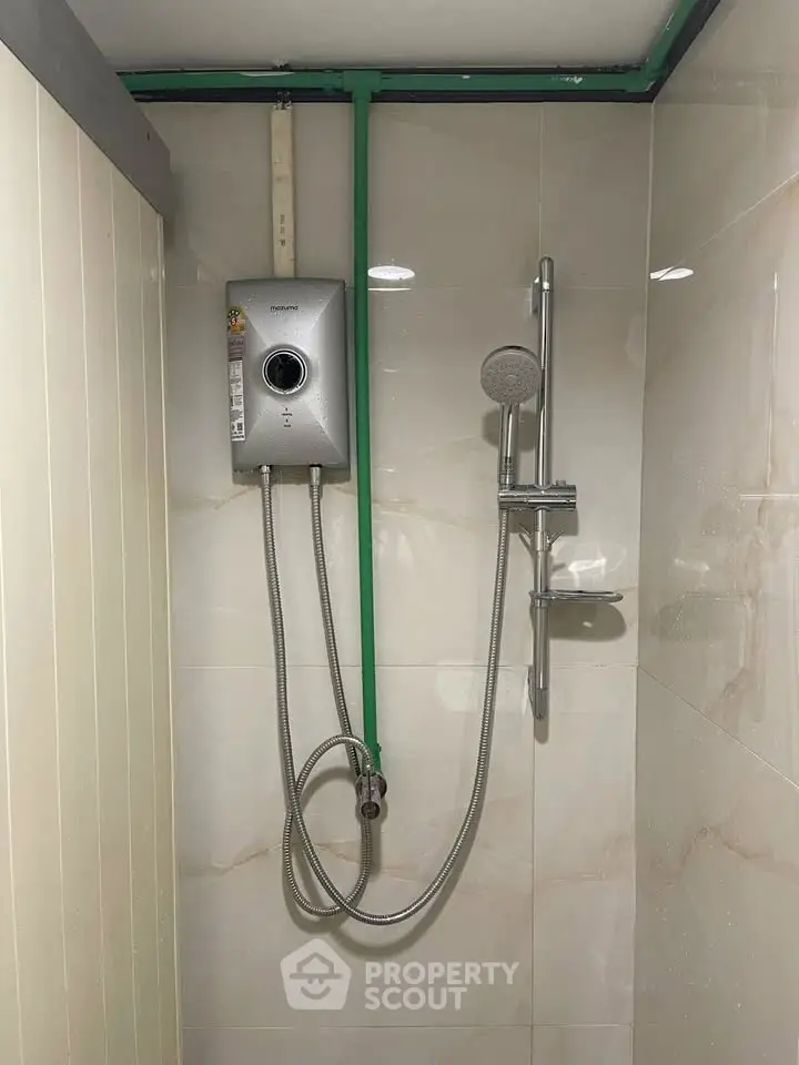 Modern bathroom shower with water heater and sleek tile design