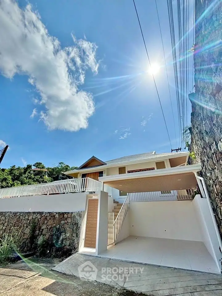 Stunning modern house exterior with bright sunlight and clear blue sky