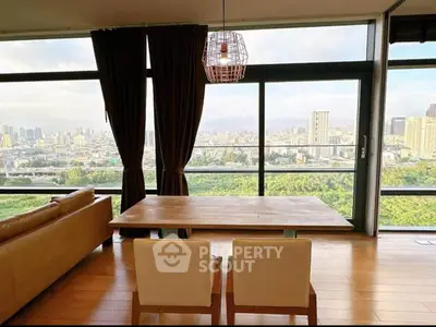 Stunning city view from modern living room with floor-to-ceiling windows and elegant decor.
