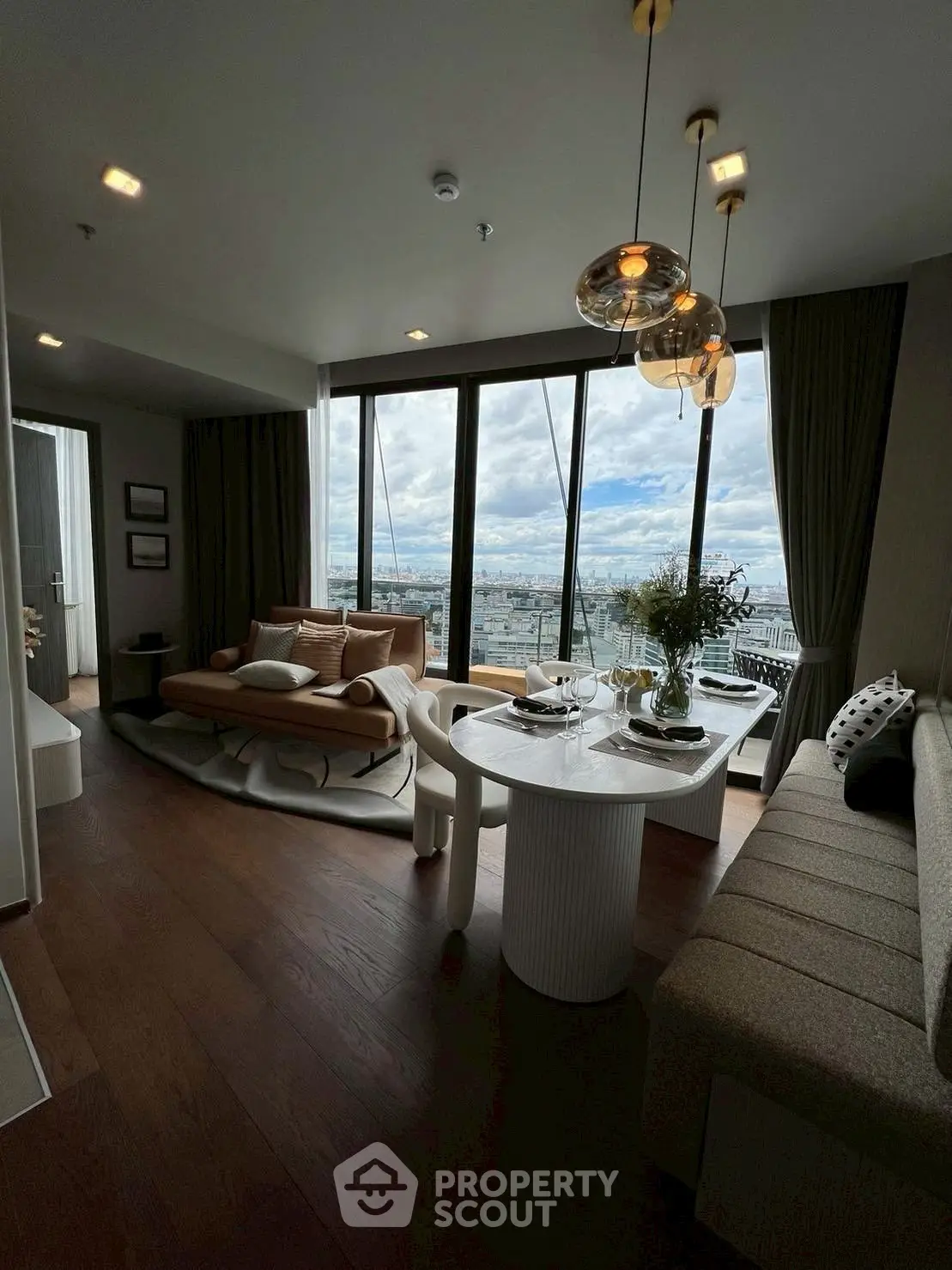 Luxurious living room with stunning city view, elegant decor, and modern furniture.