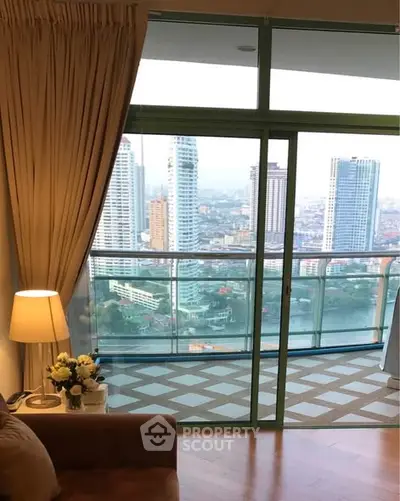 Luxurious living room with stunning city view from high-rise balcony, perfect for urban lifestyle seekers.