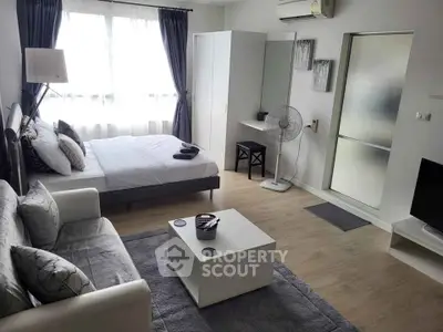 Modern studio apartment with cozy furnishings and natural light