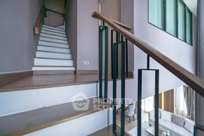 Modern duplex interior with stylish staircase and cozy living area